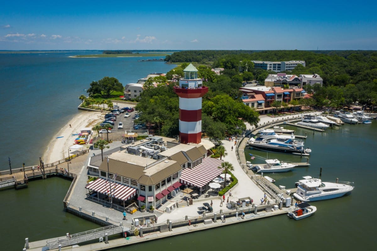 A lighthouse sits on the edge of an island.